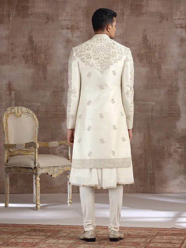 Cream silk peshwai sherwani with heavy embellishments