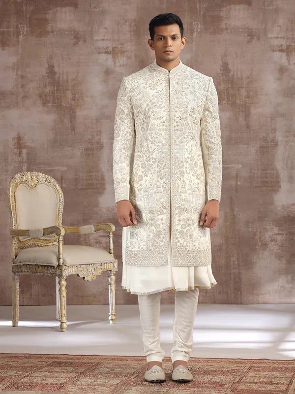 Cream silk peshwai sherwani with heavy embellishments