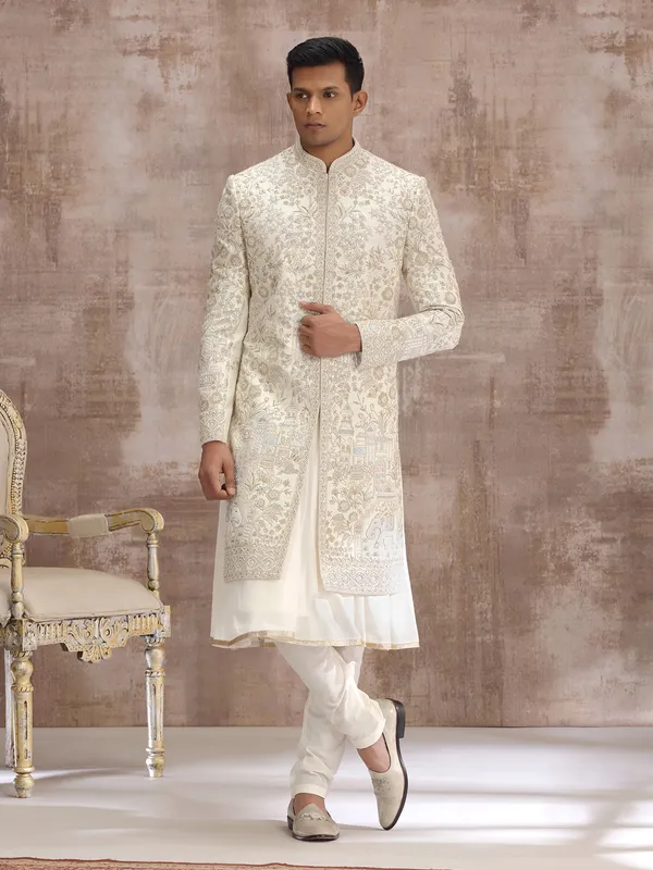 Cream silk peshwai sherwani with heavy embellishments