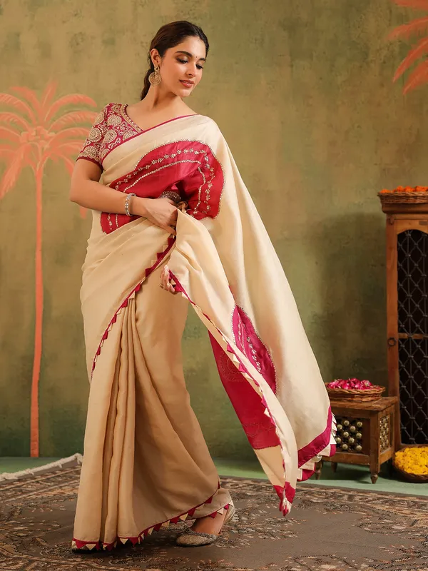 Cream silk printed saree with bold blouse