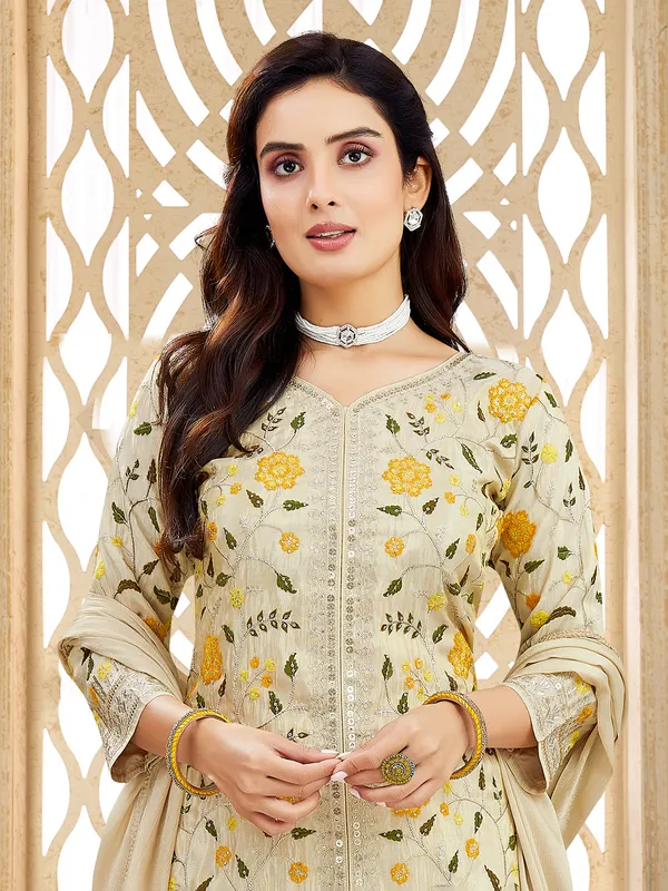 Cream silk salwar suit with zari and and mbellishments