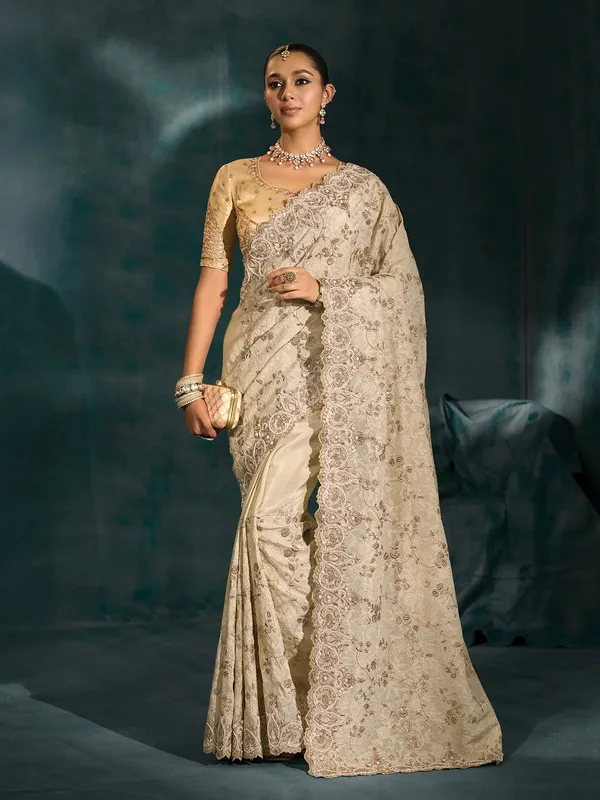 Cream silk saree for wedding celebration