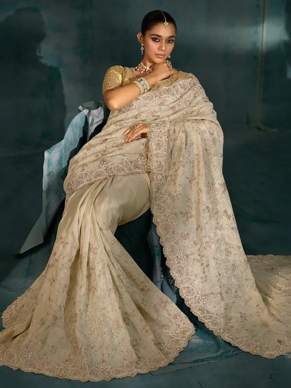 Cream silk saree for wedding celebration