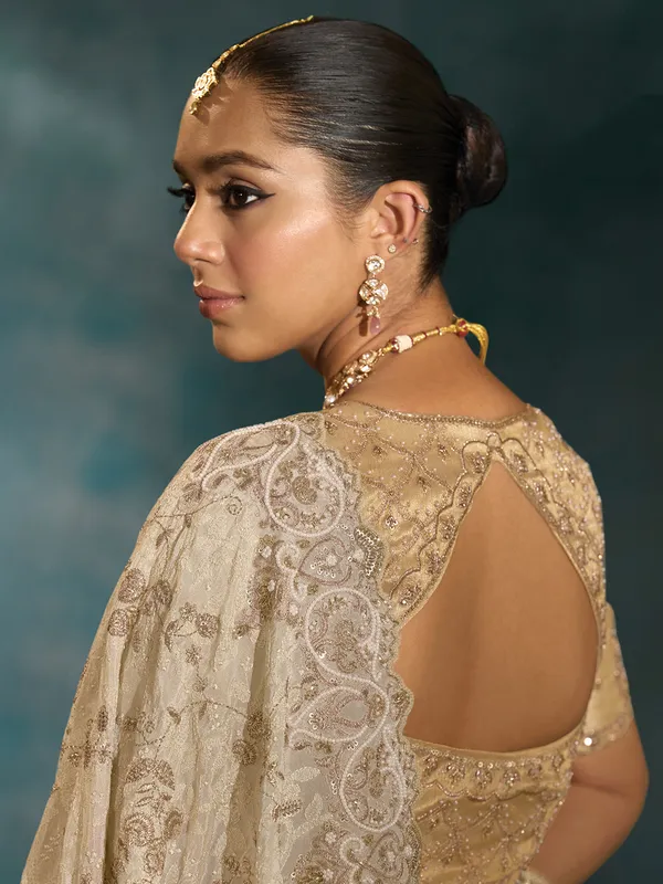 Cream silk saree for wedding celebration