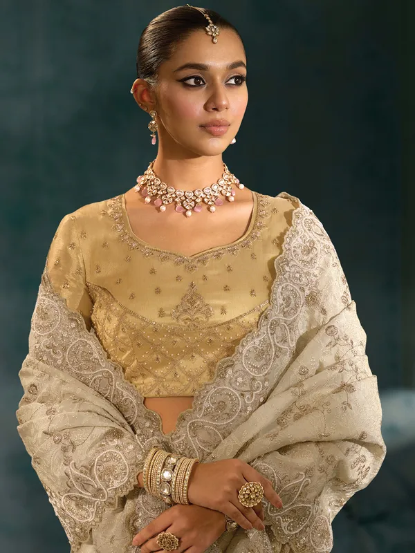 Cream silk saree for wedding celebration