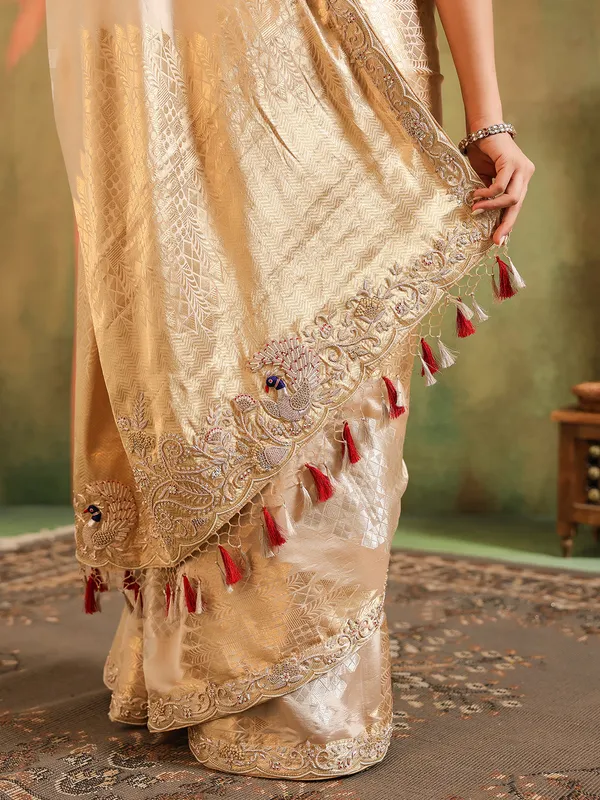 Cream silk saree for wedding celebration with red blouse