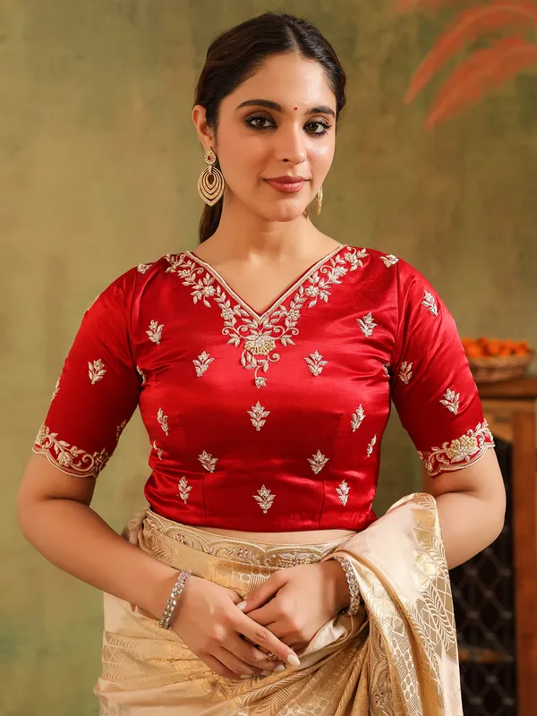 Cream silk saree for wedding celebration with red blouse
