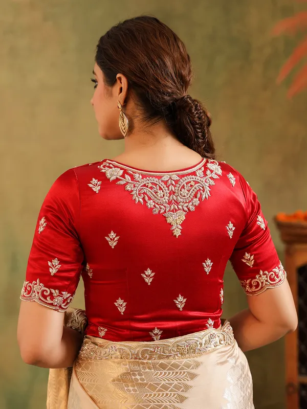 Cream silk saree for wedding celebration with red blouse