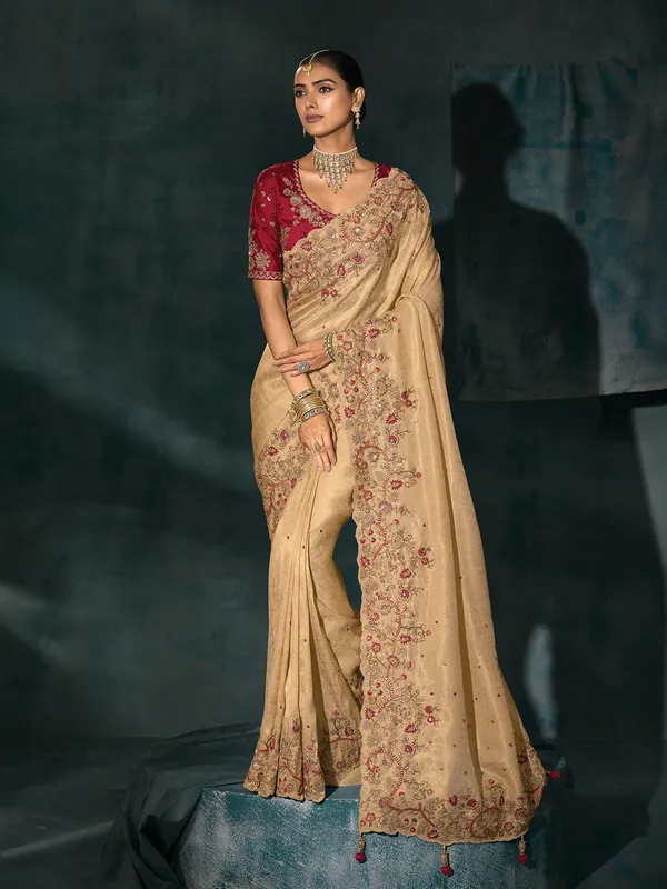 Cream silk saree with bold maroon blouse