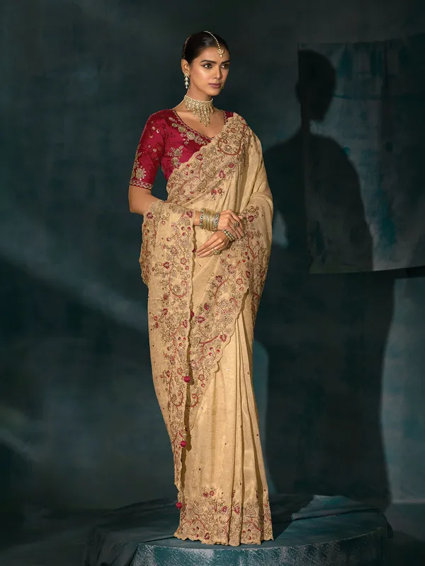 Cream silk saree with bold maroon blouse