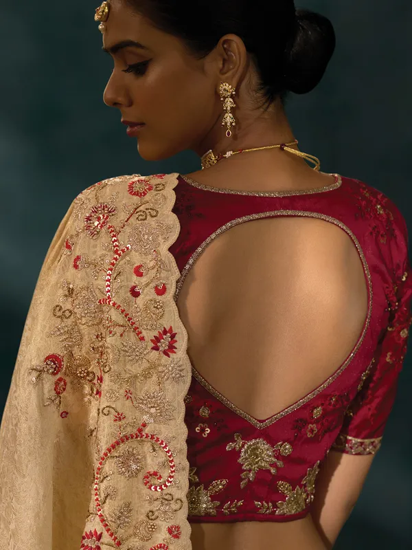 Cream silk saree with bold maroon blouse