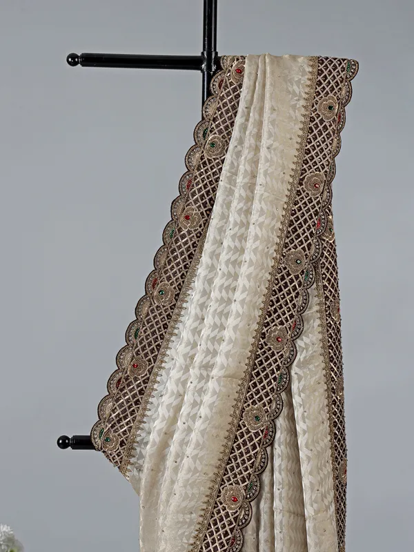 Cream silk saree with stone and zardosi work