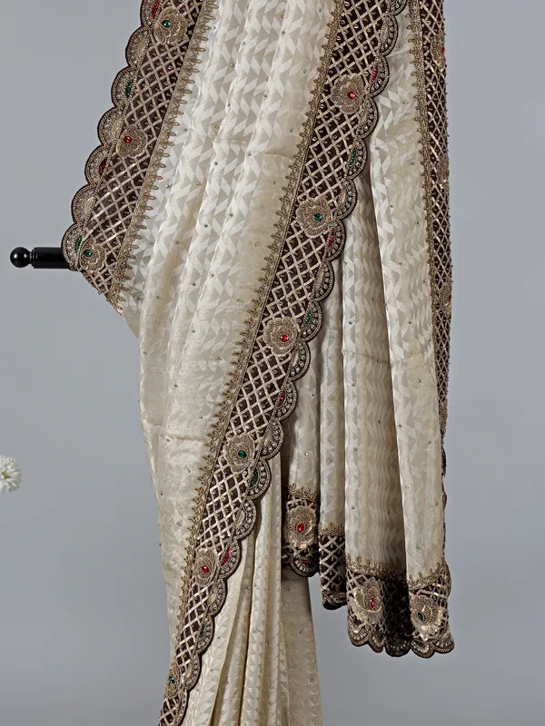 Cream silk saree with stone and zardosi work