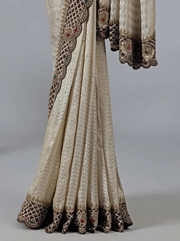 Cream silk saree with stone and zardosi work