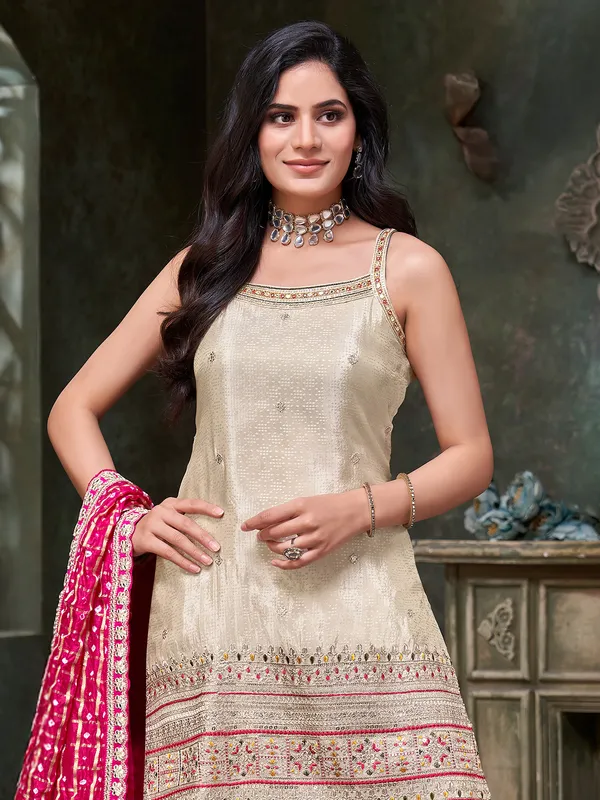 cream silk sharar suit with bold dupatta