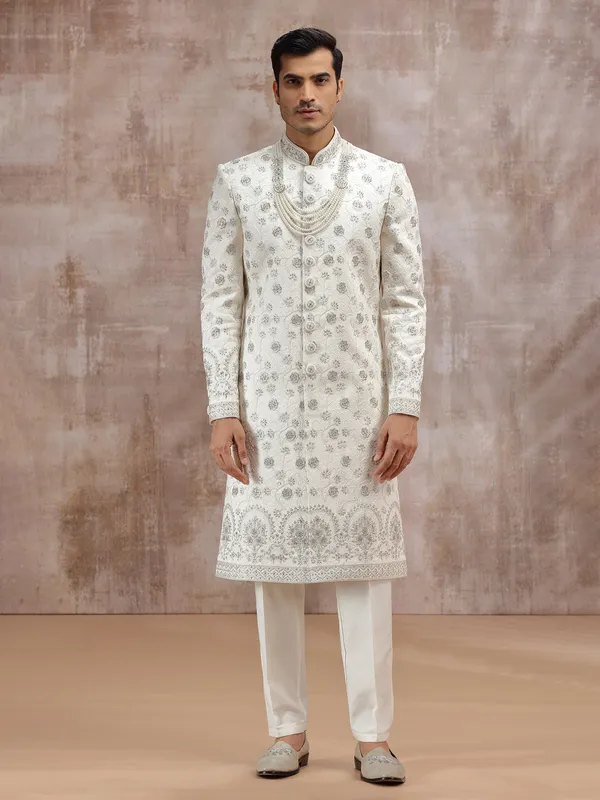 Cream silk sherwani enhanced with thread embroidery
