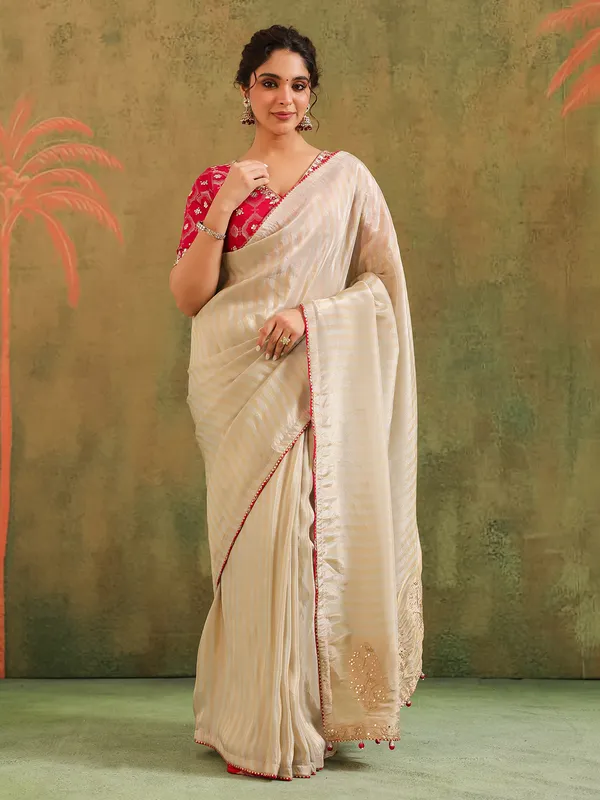 Cream silk zari worked saree with red blouse wedding look