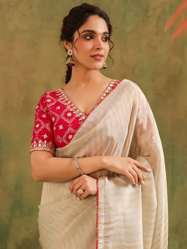 Cream silk zari worked saree with red blouse wedding look