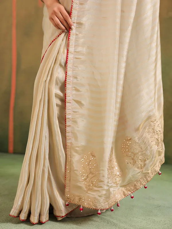 Cream silk zari worked saree with red blouse wedding look