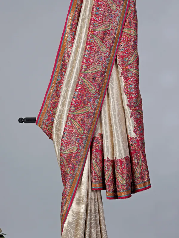 Cream tissue silk saree with colorful motifs embellishments