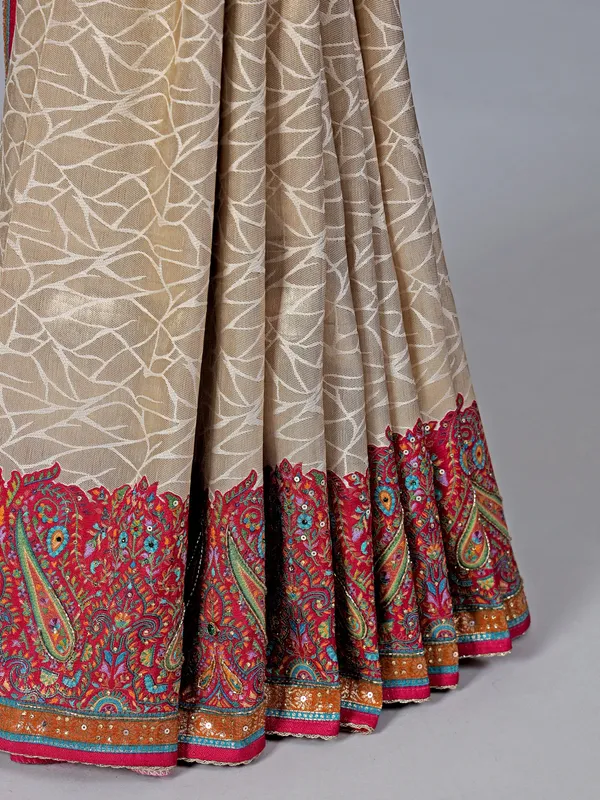 Cream tissue silk saree with colorful motifs embellishments