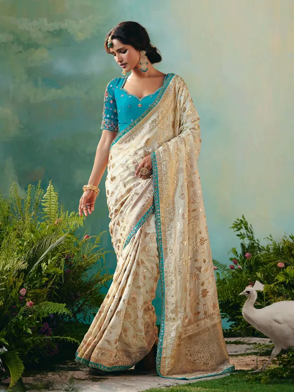 Cream viscose dola silk saree with zari work