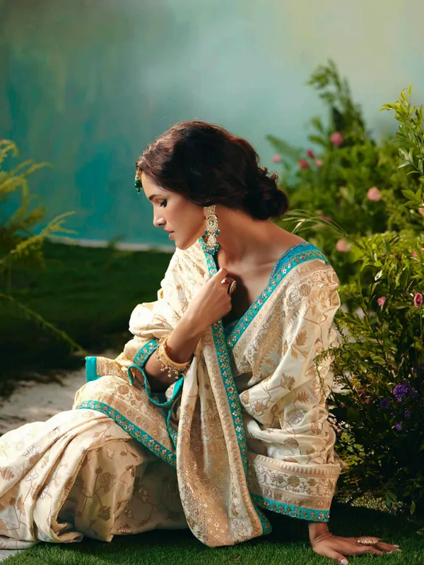 Cream viscose dola silk saree with zari work