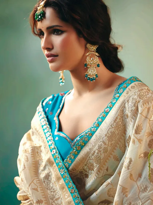 Cream viscose dola silk saree with zari work