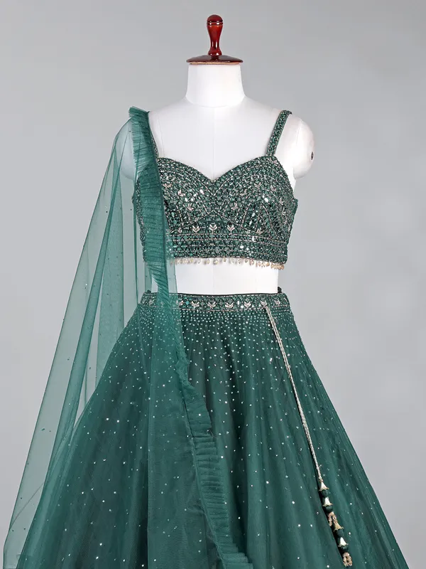 Dark green net lehenga choli with shimmering sequins