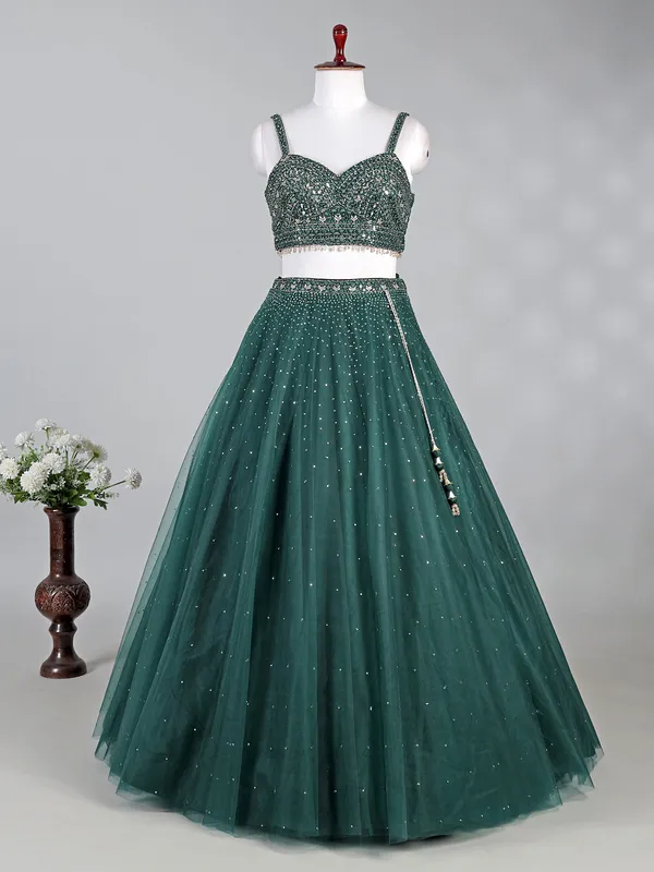 Dark green net lehenga choli with shimmering sequins