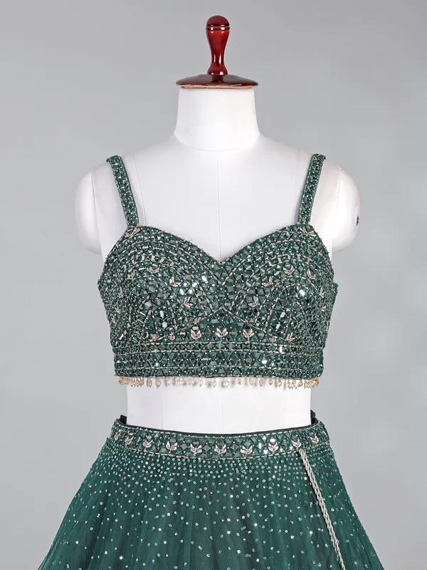 Dark green net lehenga choli with shimmering sequins