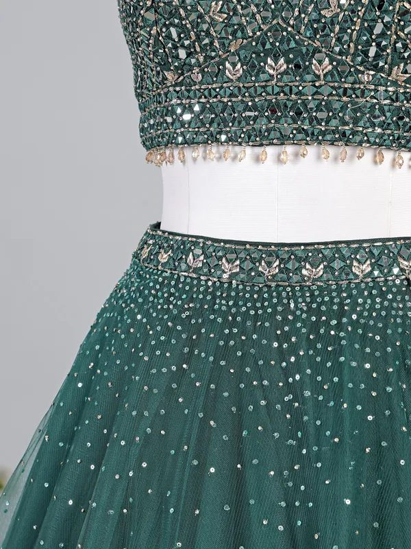 Dark green net lehenga choli with shimmering sequins