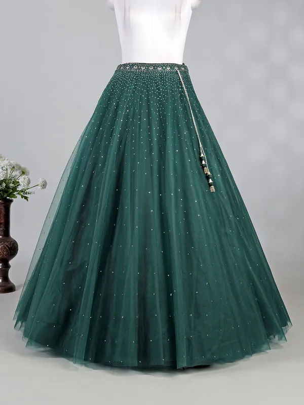 Dark green net lehenga choli with shimmering sequins
