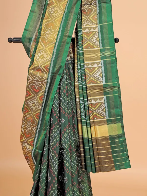 Dark green patola silk saree