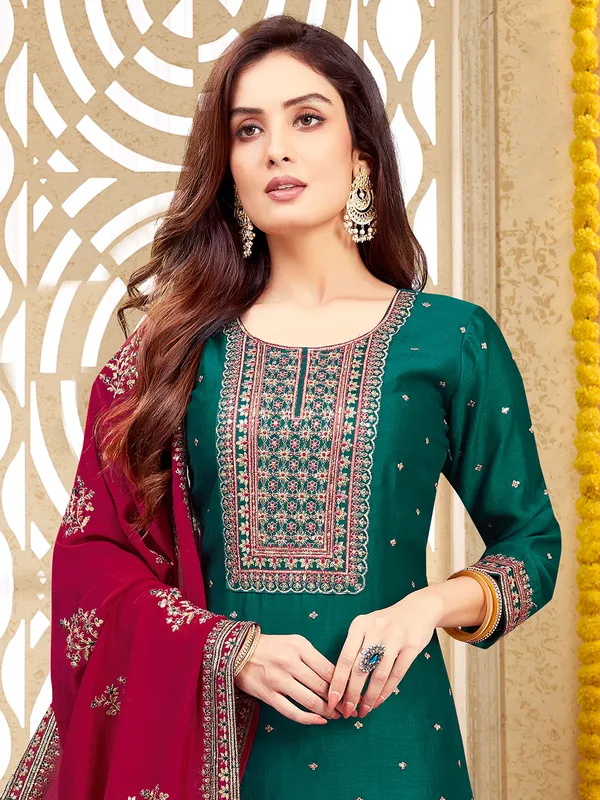 Dark green silk salwar suit with maroon dupatta