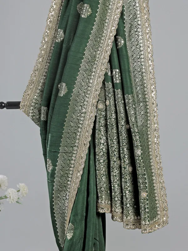 Dark green silk saree with heavy work blouse