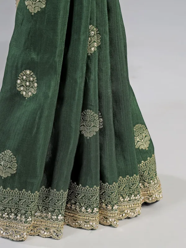Dark green silk saree with heavy work blouse