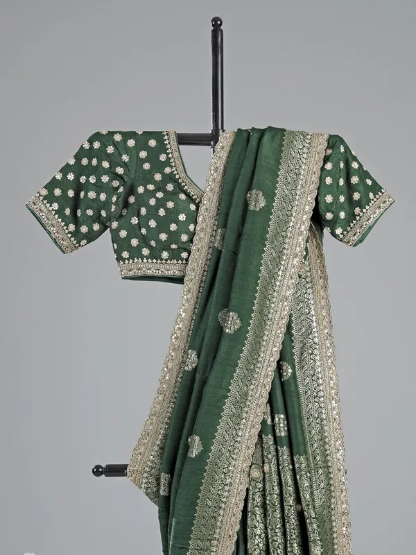 Dark green silk saree with heavy work blouse