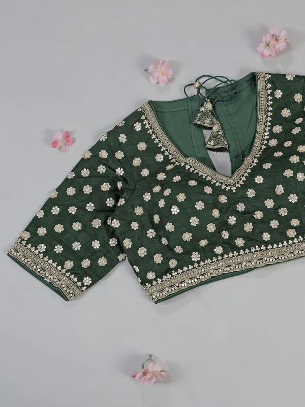 Dark green silk saree with heavy work blouse