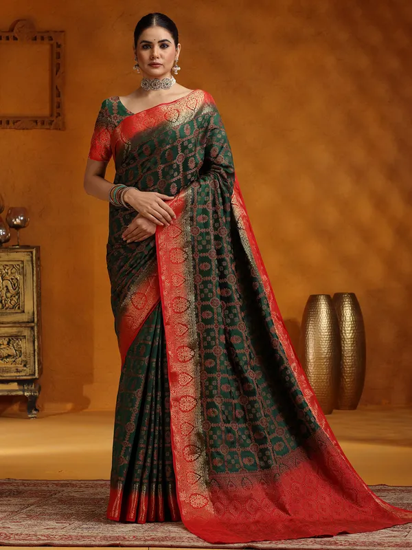 Dark green silk saree with red border