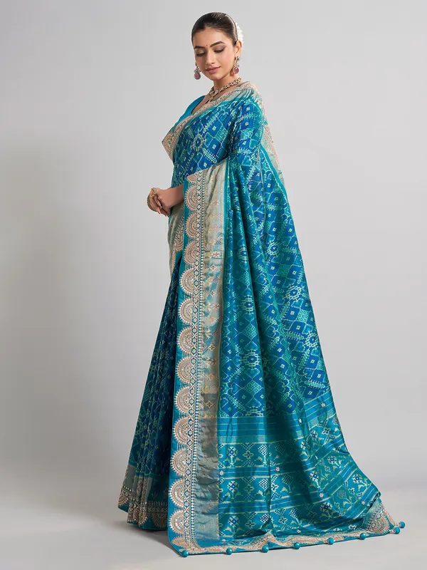 Embellished blue patola silk saree for grand festivities