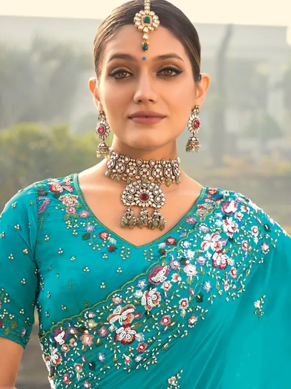 Firozi crape saree with graceful ethnic touch