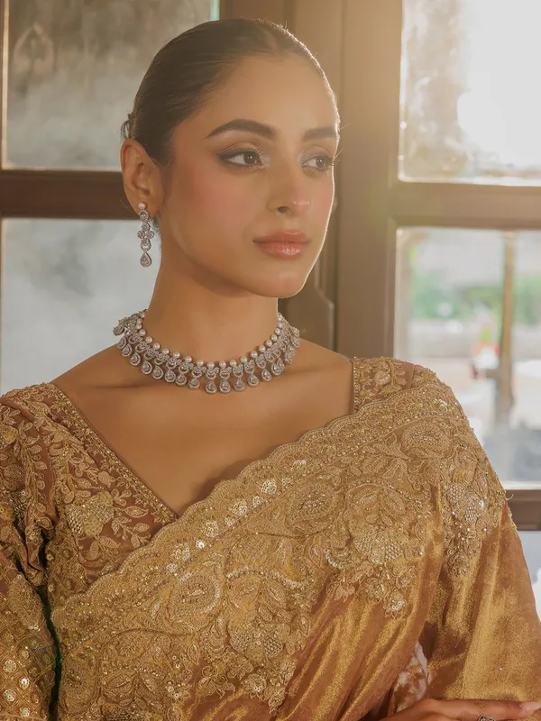 Gold silk saree with rich embellishment
