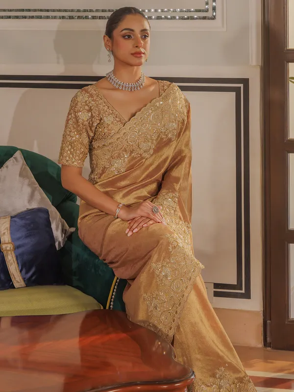Gold silk saree with rich embellishment