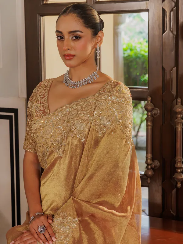 Gold silk saree with rich embellishment