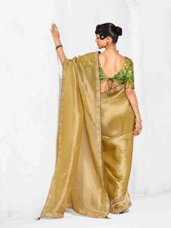 Gold tissue silk saree highlighted for festive