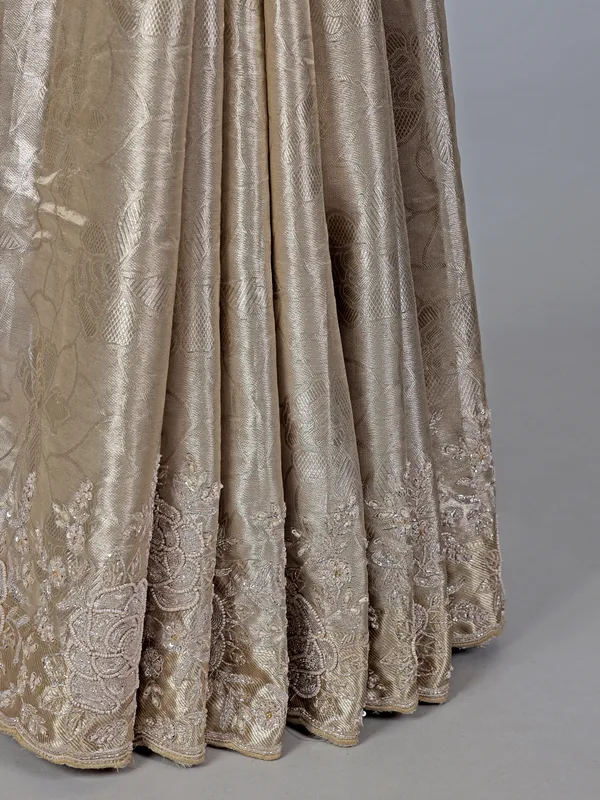 Golden tissue silk saree with bridal embellishments