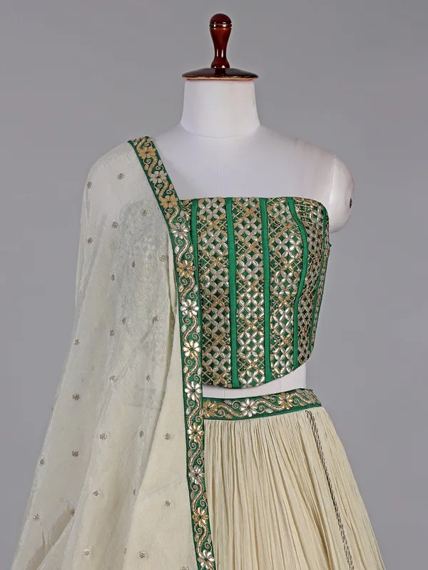 Green and cream silk lehenga choli with resham detailing