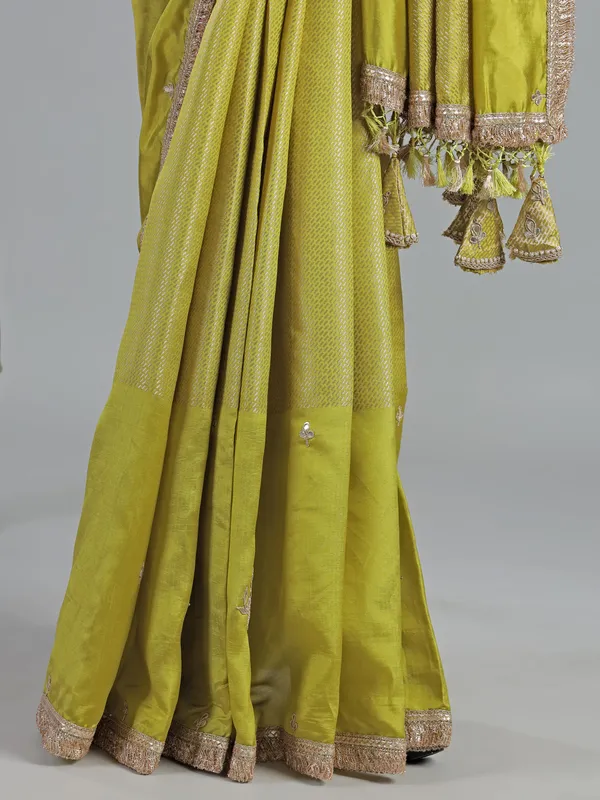 Green dola silk saree with zardosi & gota accents