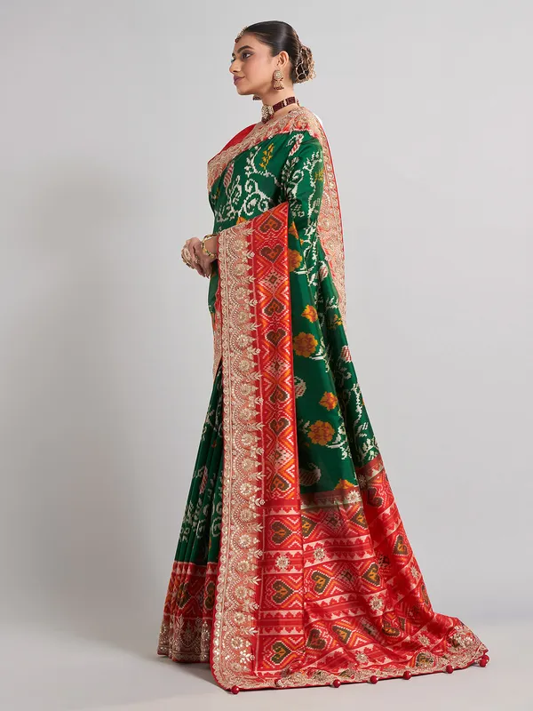Green hyderabadi patola silk saree with contrast border work